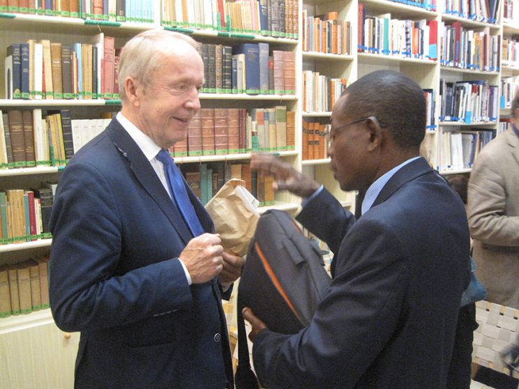 Prof. Jean-Claude Mbarga hands over the prospectus of a cultural academy in Africa